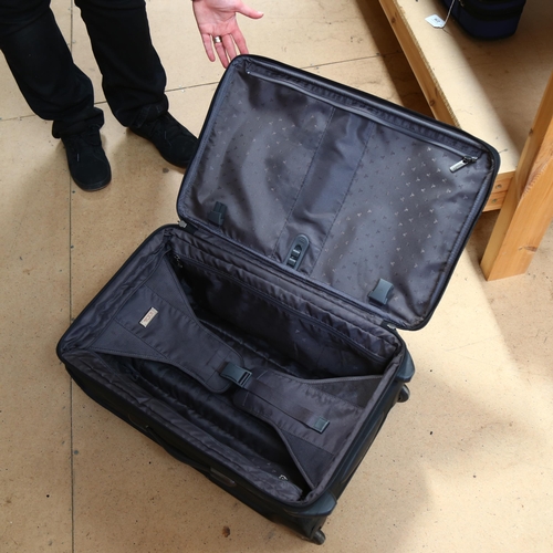 79 - A Tumi wheeled suitcase, with label to the inside, no. 22022D4, H58cm not including handle