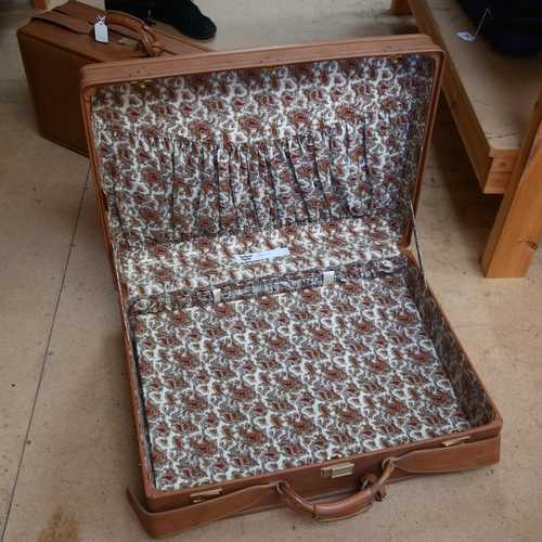 80 - A graduated pair of Hartmann leather suitcases, with paisley interiors, largest width 61cm, smallest... 