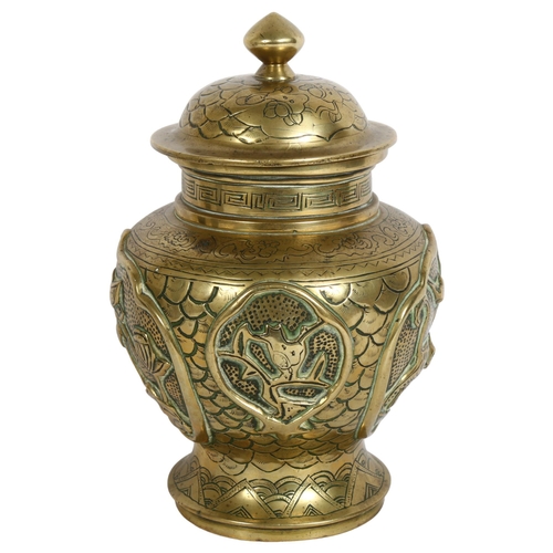 207 - A brass Chinese preserve pot with lid, with high relief decoration in various animals, including var... 