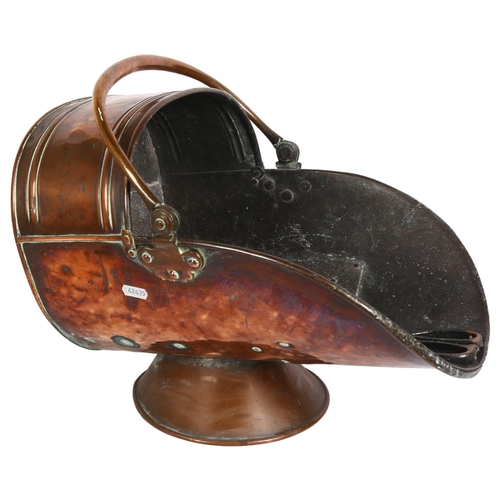 210 - A Victorian copper coal scuttle of helmet shape, with traditional cast-iron coal tongs