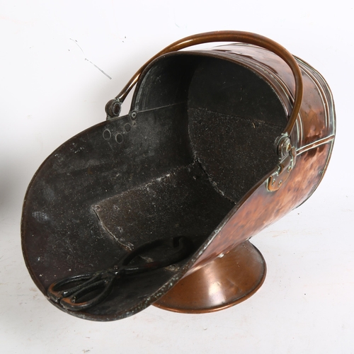 210 - A Victorian copper coal scuttle of helmet shape, with traditional cast-iron coal tongs