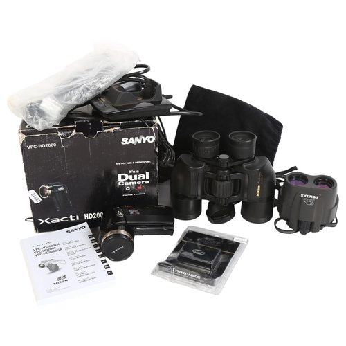 228 - A pair of Nikon Action 8x40, 8.2 degree binoculars, a Sanyo Xacti HD2000 dual camera and camcorder, ... 