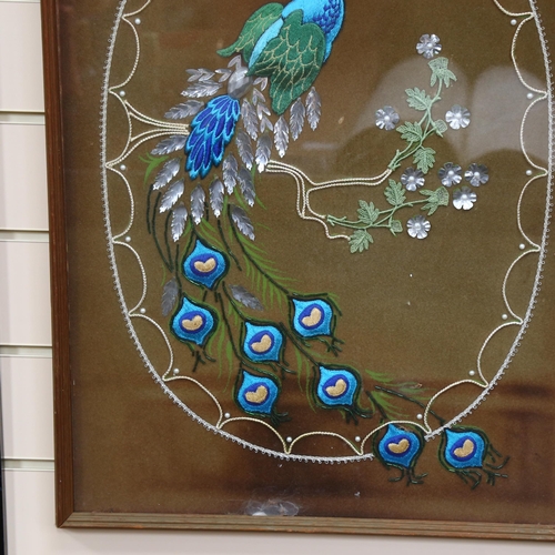 296 - A framed silk embroidery, with applique needlework of an impressive peacock seated on a brand of seq... 