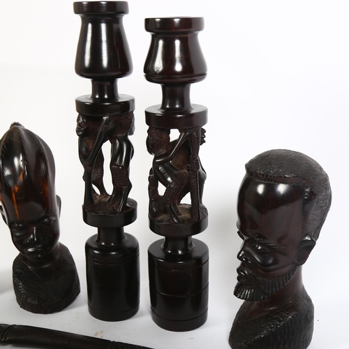 322 - A group of ebony wood carved items, including a pair of decorative candle holders, with carved Triba... 