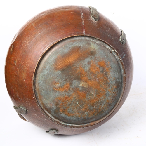 459 - A large Eastern hammered copper pot, with engraved cast-metal handles, diameter 39cm