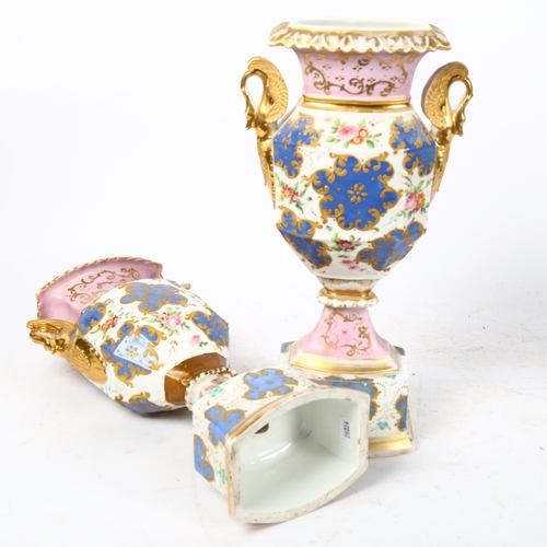 463 - A pair of porcelain vases, with gilded swan handles and painted floral decoration, H32cm