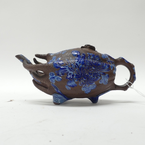 143 - A Chinese terracotta teapot in the form of a gourd, with blue enamel painted decoration, L19cm, and ... 