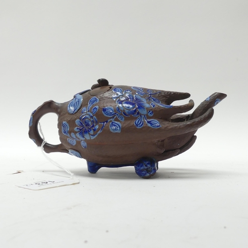 143 - A Chinese terracotta teapot in the form of a gourd, with blue enamel painted decoration, L19cm, and ... 