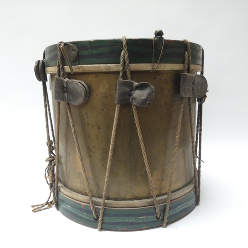 22 - A 20th century military drum, with brass body and painted wood mounts, H38cm, D37cm, and a pair of d... 