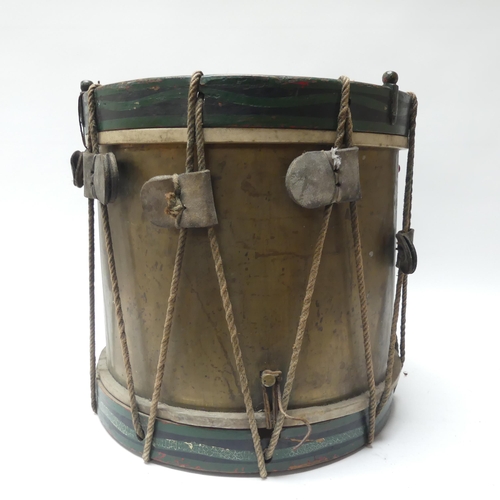 22 - A 20th century military drum, with brass body and painted wood mounts, H38cm, D37cm, and a pair of d... 