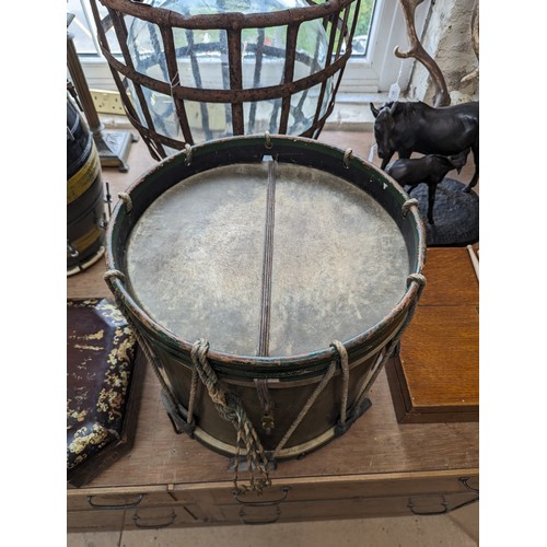 22 - A 20th century military drum, with brass body and painted wood mounts, H38cm, D37cm, and a pair of d... 