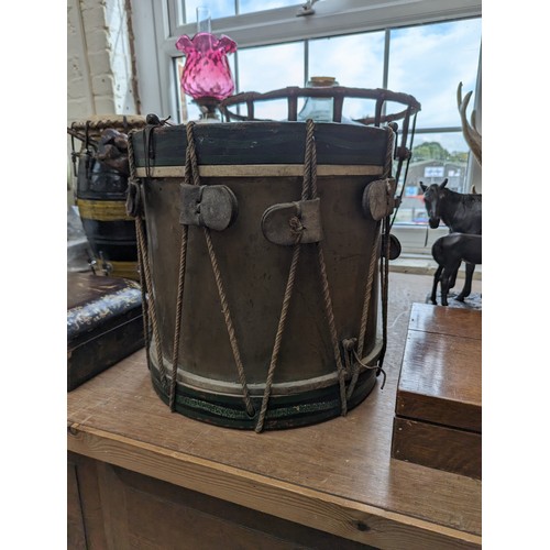 22 - A 20th century military drum, with brass body and painted wood mounts, H38cm, D37cm, and a pair of d... 