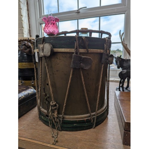 22 - A 20th century military drum, with brass body and painted wood mounts, H38cm, D37cm, and a pair of d... 