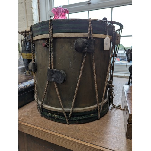 22 - A 20th century military drum, with brass body and painted wood mounts, H38cm, D37cm, and a pair of d... 