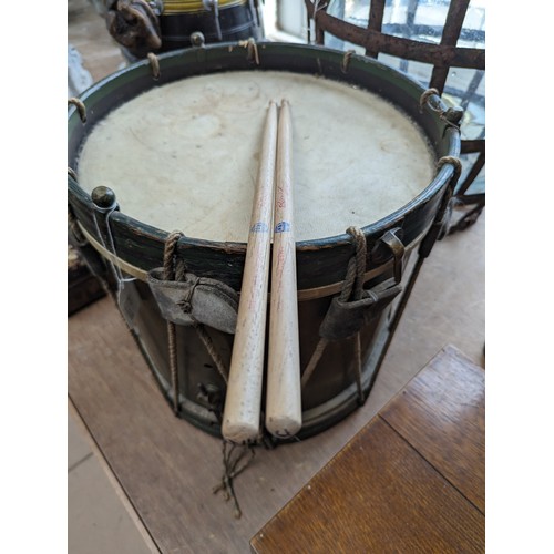 22 - A 20th century military drum, with brass body and painted wood mounts, H38cm, D37cm, and a pair of d... 