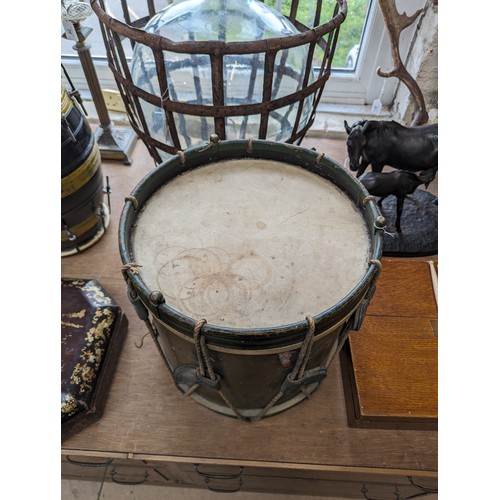 22 - A 20th century military drum, with brass body and painted wood mounts, H38cm, D37cm, and a pair of d... 