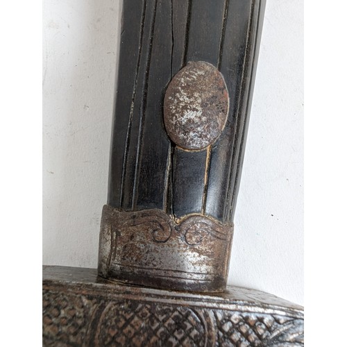 56 - An Indo-Persian short curved sword with steel guard and carved wood handle, together with leather sc... 