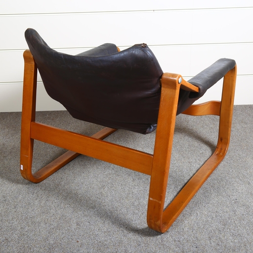 22 - Maurice Prentice Burke, a rare leather lounge chair, the beech frame with sled base, with maker’s la... 