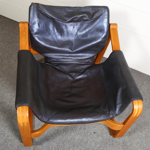 22 - Maurice Prentice Burke, a rare leather lounge chair, the beech frame with sled base, with maker’s la... 