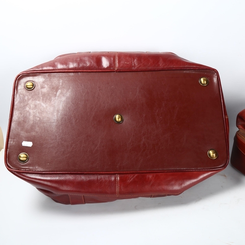 29 - Jacob Fine Leather, a pair of burgundy leather weekend bags, one with original label