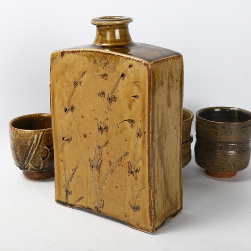 45 - Phil Rogers (1951-2020), a studio pottery ash glaze slab bottle, together with 4 Yunomi / tea-bowls,... 