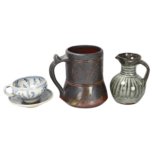 73 - 3 pieces of Studio pottery, Seth Cardew cup and saucer and a large Abuja pottery tankard, both with ... 