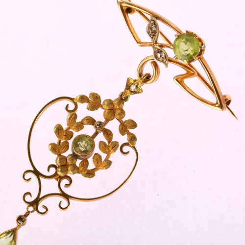 1102 - An Edwardian Art Nouveau 15ct gold peridot and diamond openwork drop brooch, set with pear and round... 