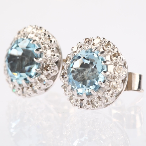 1126 - A pair of aquamarine and diamond round cluster earrings, unmarked white metal settings with round-cu... 