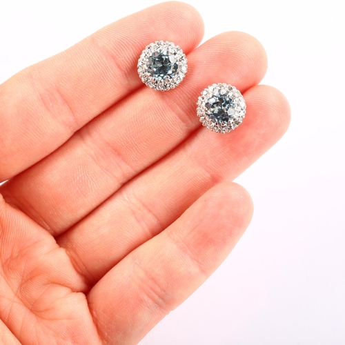 1126 - A pair of aquamarine and diamond round cluster earrings, unmarked white metal settings with round-cu... 