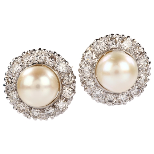 1139 - A pair of whole pearl and diamond round cluster earrings, unmarked white gold settings test as 18ct,... 