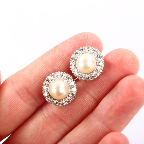 1139 - A pair of whole pearl and diamond round cluster earrings, unmarked white gold settings test as 18ct,... 