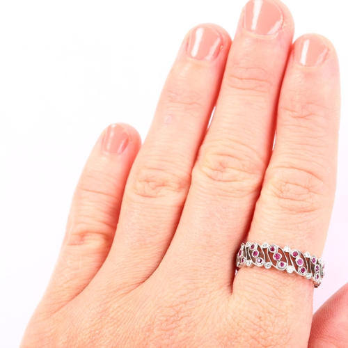 1142 - LUKE STOCKLEY - an 18ct white gold ruby and diamond full eternity ring, in Art Deco style, pierced o... 