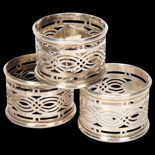 1551 - A cased set of George V silver napkin rings, Britton, Gould & Co, Birmingham 1928, cylindrical form ... 