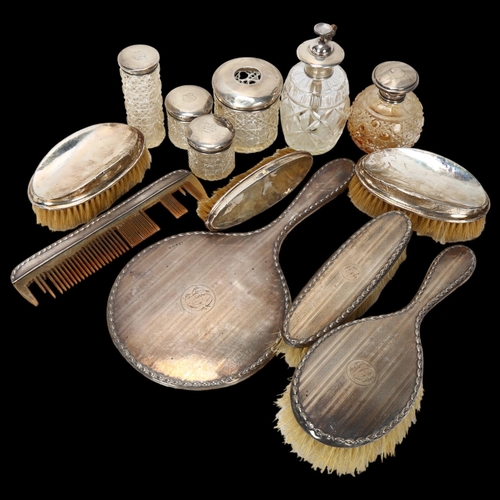 1558 - Various silver dressing table items, including hand mirror, toilet jars, brushes etc