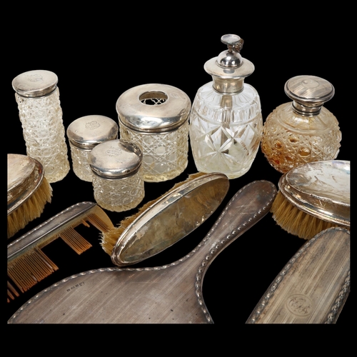 1558 - Various silver dressing table items, including hand mirror, toilet jars, brushes etc