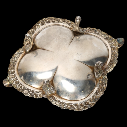 1561 - A Continental sterling silver ashtray, lobed form with relief embossed floral rim, on 4 feet, width ... 