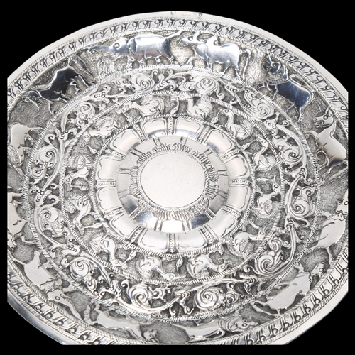 1569 - An Indian silver dish, relief embossed animal decoration, indistinct marks on rim, diameter 14cm, 2.... 