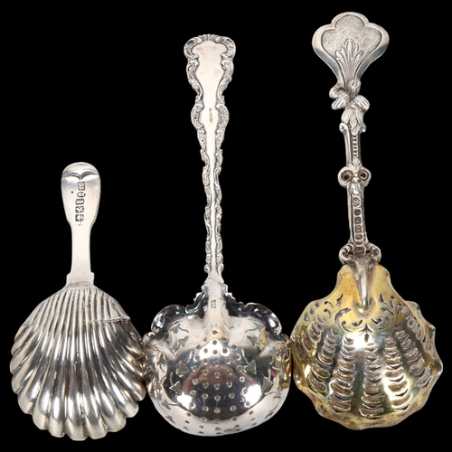 1580 - A William IV Scottish silver shell caddy spoon, and 2 decorative cast-silver sifter spoons, largest ... 