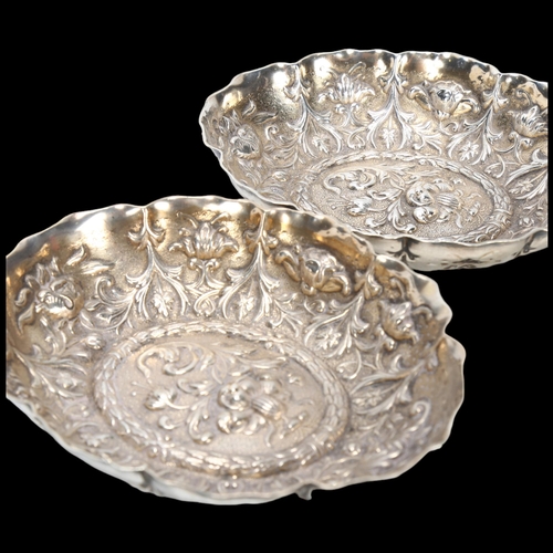 1585 - A pair of Victorian silver dishes, William Comyns, London 1889, oval lobed form with relief embossed... 