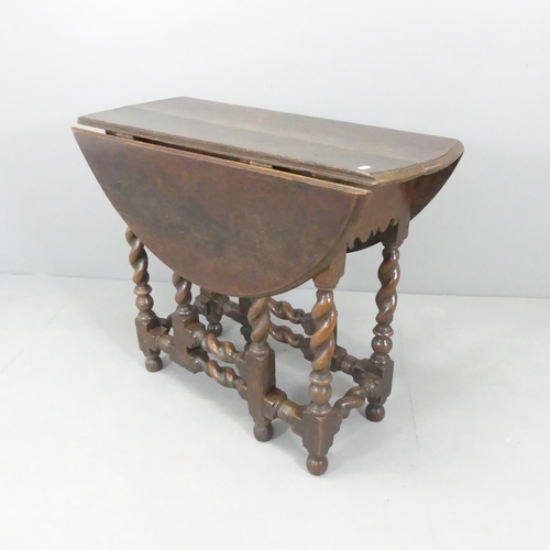 2607 - An 18th century oak oval drop-leaf gate-leg table on barley twist legs. 92x75x35cm (extending to 102... 