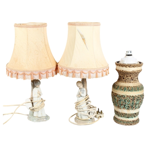 916 - A pair of Spanish figure table lamps and shades, and an embossed pottery table lamp with shade