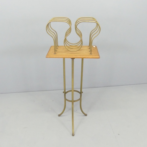 2580 - A Victorian brass revolving magazine rack. 38x100x23cm