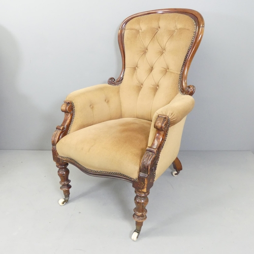 2584 - A Victorian mahogany and button-back upholstered spoon back armchair.