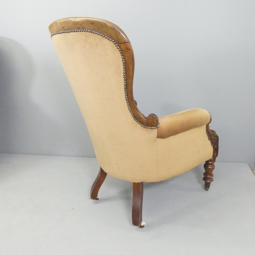 2584 - A Victorian mahogany and button-back upholstered spoon back armchair.