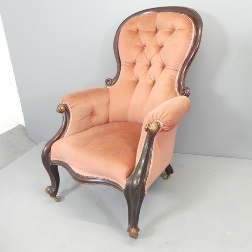 2585 - A Victorian mahogany and button-back upholstered spoon back armchair.