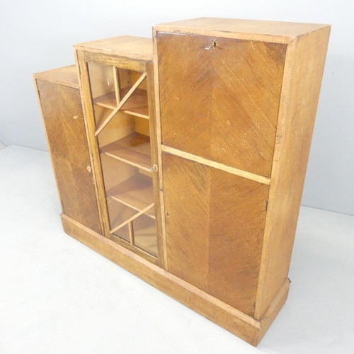 2586 - An Art Deco teak and oak veneered drinks cabinet of stepped form, with four compartments behind one ... 