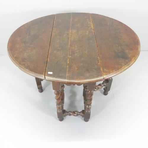 2607 - An 18th century oak oval drop-leaf gate-leg table on barley twist legs. 92x75x35cm (extending to 102... 