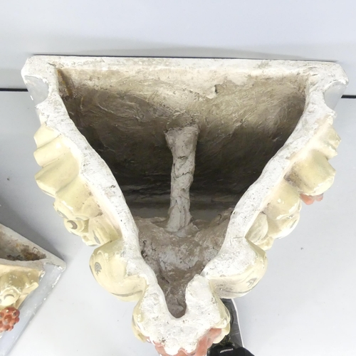 2610 - A pair of painted plaster corbels. Each 49x46x41cm