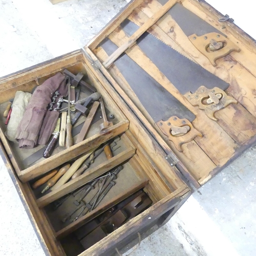 2614 - A carpenter's tool chest containing various wood-working tools including awls, planes, saws etc. 92x... 