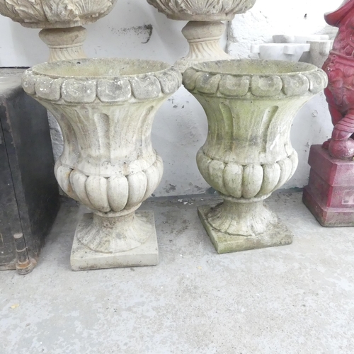 2630 - A pair of weathered concrete campana style urns. 43x58cm